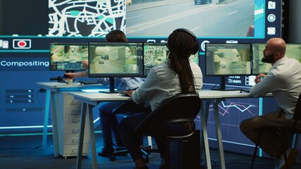 Cargo shipping agency employees monitoring their cars and drivers to ensure express delivery using...