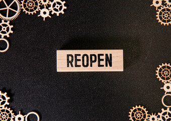 torn paper revealing the word REOPEN