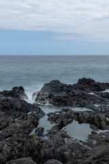 Photograph silky water long exposure on rocks in the middle of the sea. Concept: Water, silky water, sea, maritime.