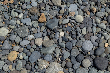 Textured grey beach pebbles. Concept: Nature, rocks, stones, beach.