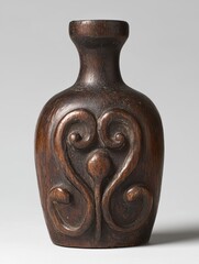 Carved wooden vase with abstract design