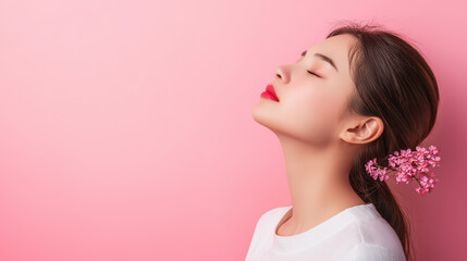 Woman in white top meditating with eyes closed against soft pink background, representing calmness, mindfulness, and serenity in a peaceful and balanced life