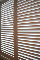 close up of an open window with shutters