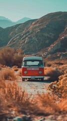 Obraz premium A classic orange vintage camper van is parked on a dusty road surrounded by desert mountains, evoking a sense of freedom, solitude, and adventure in a remote wilderness setting.