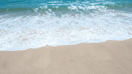 Sandy beach and soft blue Sea wave of the sea