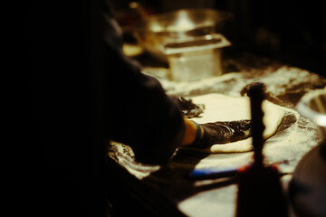 Pizzaiolo shaping the dough for a pizza