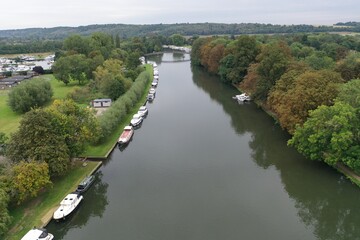 Aerial view of a river with boats on the side of the river