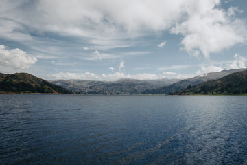 Lake and mountains in the background , sky with clouds, peaceful scene