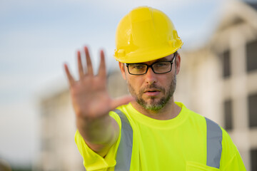 Construction worker having coffee break on construction site.Builder in helmet. Worker in hardhat....