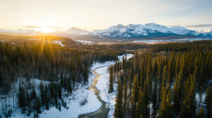 A winter alpine landscape, featuring snow-capped peaks, frozen rivers winding through snow-covered forests, and the distant horizon glowing under a clear winter sky.