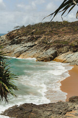 Rock and golden sand beach