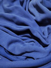 wavy abstract background made of blue fabric