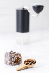 Aromatic flavorful Roasted Specialty Coffee Beans with grinder on white Background
