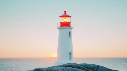 Fototapeta premium A lighthouse shines brightly on a rocky shoreline as twilight falls, casting a warm glow over the water
