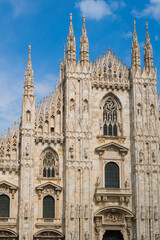 Fototapeta premium duomo di milano cathedral facade exterior top view on sky background, famous place architecture 