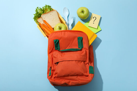 A school bag with a lunch box with food