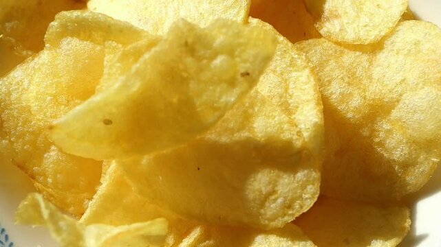 slow motion of potato chips dropping in a plate 