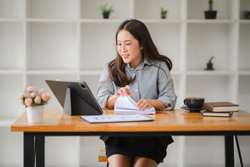 Focused Female Professional Navigates Digital Documents at a Modern Workspace 