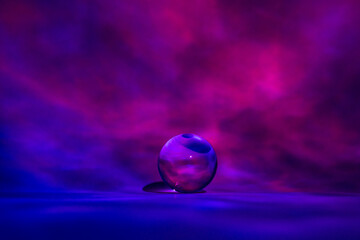 Glass ball with shades of blue and pink, like clouds at a brilliant sunset.