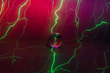 Glass ball with green light streaks, abstract with a variety of colors.