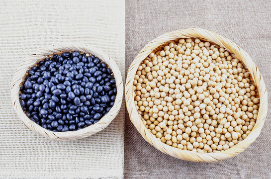 Raw dried soybeans and black geans on bamboo basket, South Korea 