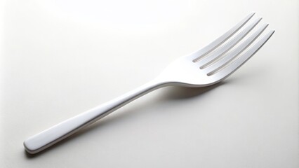 A slender white fork stands upright on a plain, isolated background, its tines pointed neatly to the left