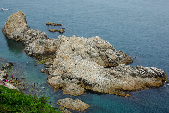 Samcheok-si, Gangwon-do, South Korea - July 19, 2019: Aerial view of tourists snorkeling at the beach besides sea rocks near Jangho Port