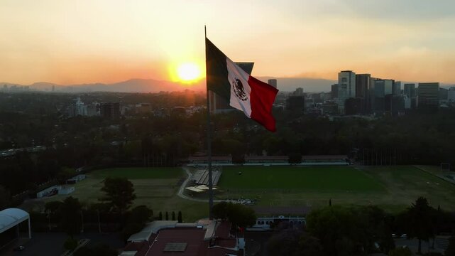 Aerial view around a large mexican flag, sunset in Chapultapec, Mexico city