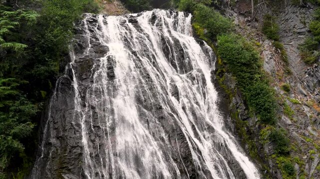 Slow motion landscape Narada Falls waterfall running stream lake river in Mount Rainier mountain forest National Park Washington Seattle nature tourism travel sightseeing