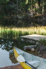 Yellow canoe in front of a wharf