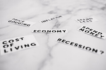 Inflation and recession concept, economic terms scatered on marble desk