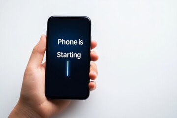 a man holding a phone and the screen showing the text " phone is starting" , illustrating phone is booting up