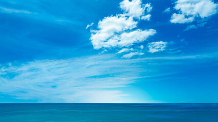 Nature of the beach and sea Summer with sunshine, sandy beaches, clear blue waters sparkling against the blue sky. On an island with good ecology and environment Background for summer vacation concept