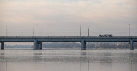 A bridge spans a river with a train crossing over it