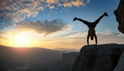 A fearless, brave and crazy person doing a handstand on the peak of the cliff and his successful moves