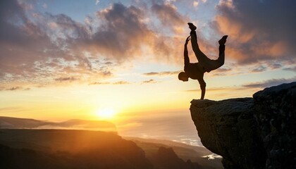 A fearless, brave and crazy person doing a handstand on the peak of the cliff and his successful moves