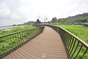 Fototapeta premium The bridge and wooden architecture built above Rawa Pening Lake has now become an aesthetic tourist spot for the people of Indonesia.