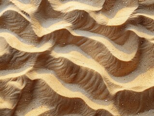 Beige sand background with soft ripples and textures for design or decoration, top view. Beige sand texture for the beach, summer concept.