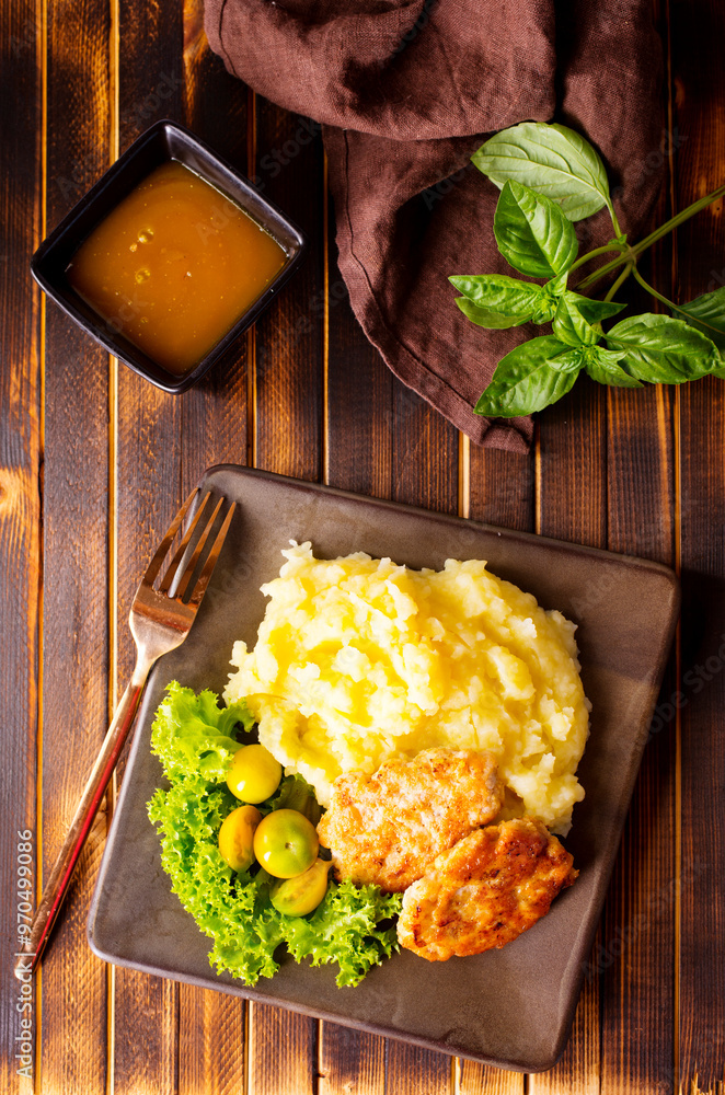 Wall mural Chicken cutlets with mashed potatoes, meat cutlets with mashed potatoes and tomatoes