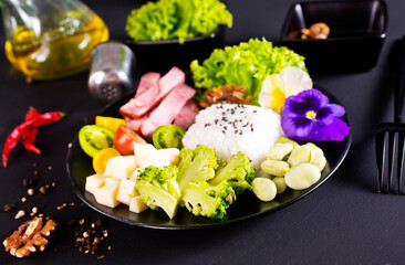 Rice and broccoli served on a plate on dark background