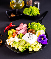 Rice and broccoli served on a plate on dark background