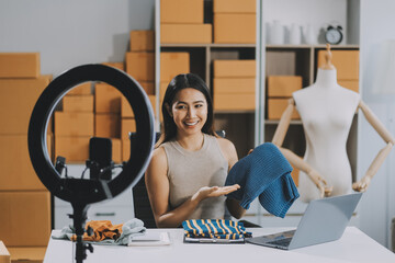 Beautiful woman review product and talking camera live recording video on social network at home,...