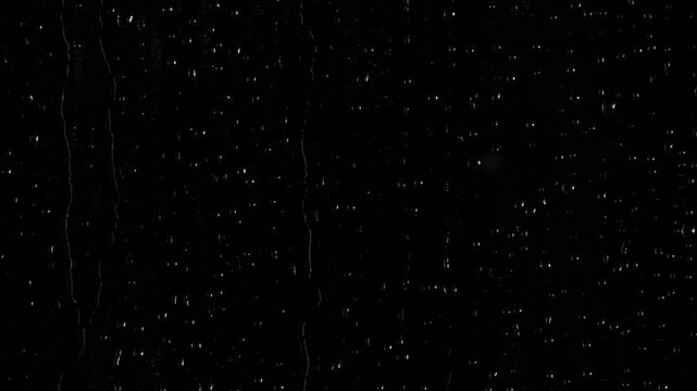 Closeup water rainfall, rain drops falling on window glass over black background