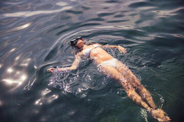 Young girl playing and swimming in the Mediterranean Sea. Spain