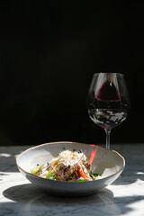 Veal salad with vegetables and teriyaki. Sliced meat and vegetables salad in a white bowl