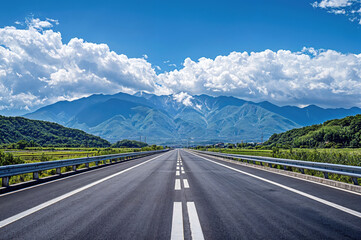 Naklejka premium Empty asphalt road leading to distant mountains under blue sky with clouds