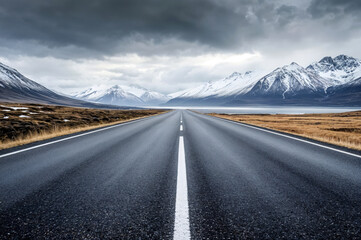 Naklejka premium Empty road leading to snowy mountains in iceland