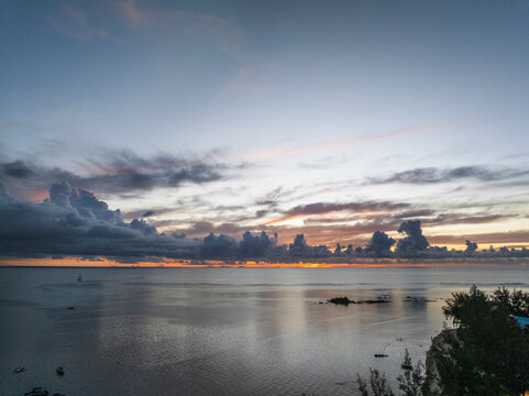 Aerial view of sunset over the ocean with sailboat. Grand Baie, Mauritius