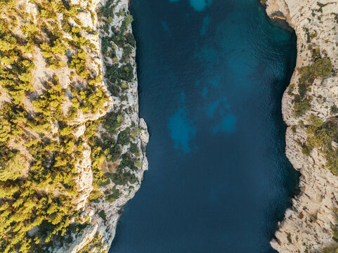 Aerial view of long narrow canyon deep into the landscape at sunrise. Cassis, France