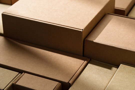 Stacked cardboard boxes arranged in a neat pattern under natural light